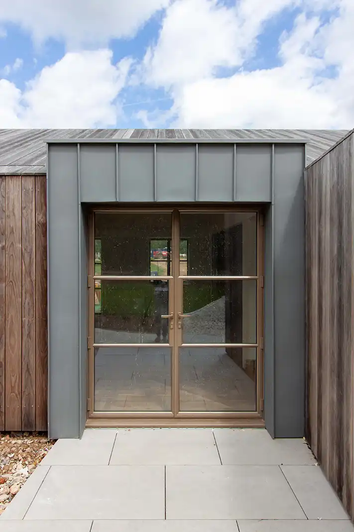 Contemporary garden building with timber cladding and metal framed glazing