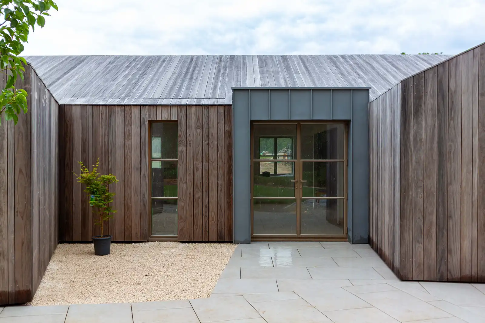 Kebony outbuilding nestled within a landscaped garden setting